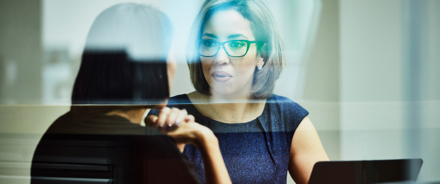 a woman in glasses looking at the camera